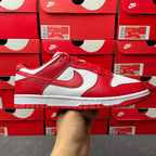 Nike Dunk Low low-top sneaker with red leather panels, white overlays, and red laces