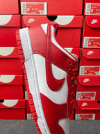 Nike Dunk Low low-top sneaker angled view with red suede-like overlays and white side panel