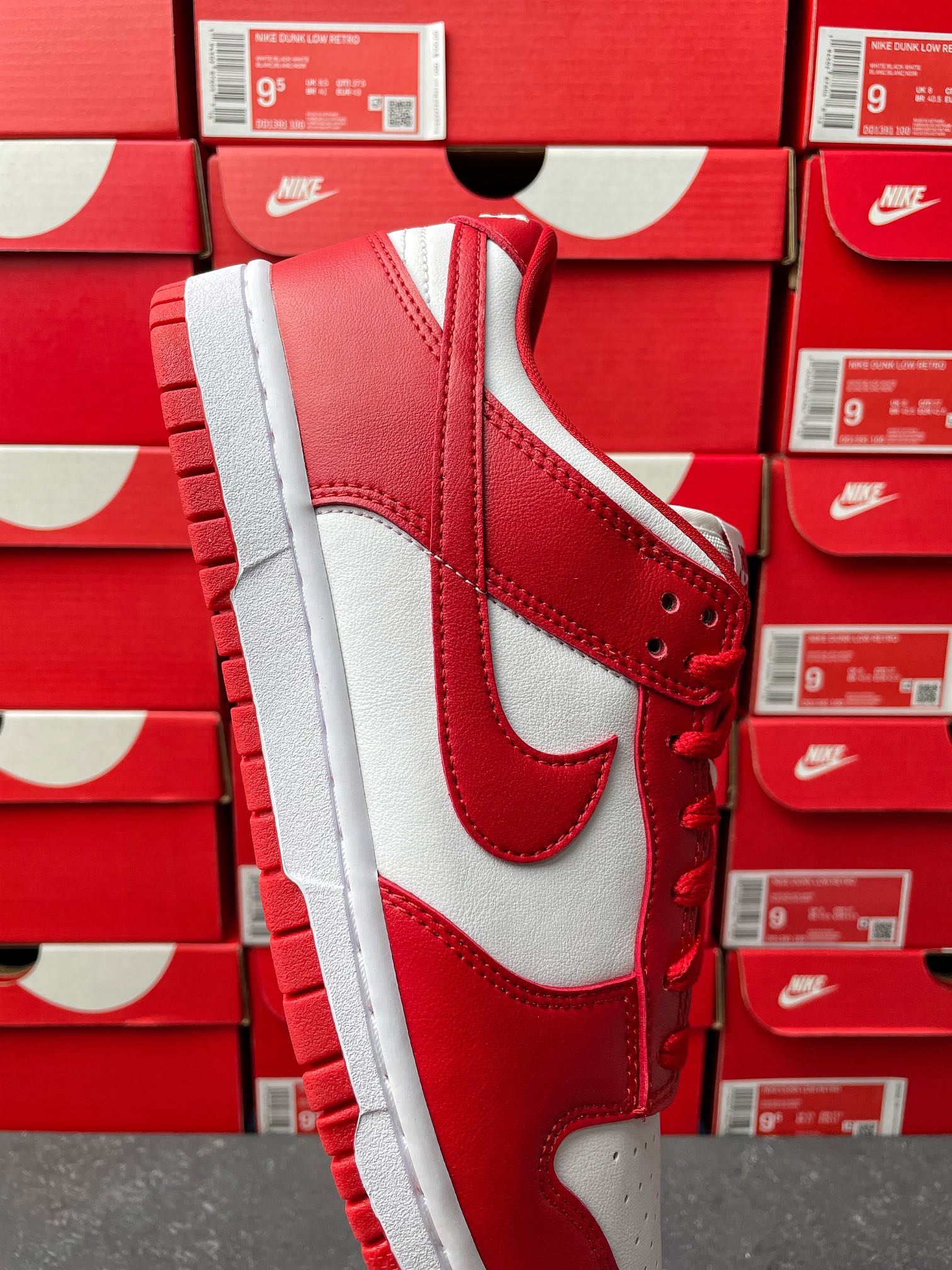 Nike Dunk Low low-top sneaker angled view with red suede-like overlays and white side panel