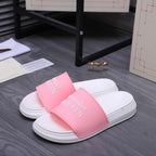 Alexander McQueen slide sandals with pink logo strap and white rubber sole