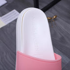 Alexander McQueen slide sandal close-up: white upper with pink strap edge