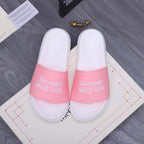 Alexander McQueen slide sandals with white footbed and pink logo strap band