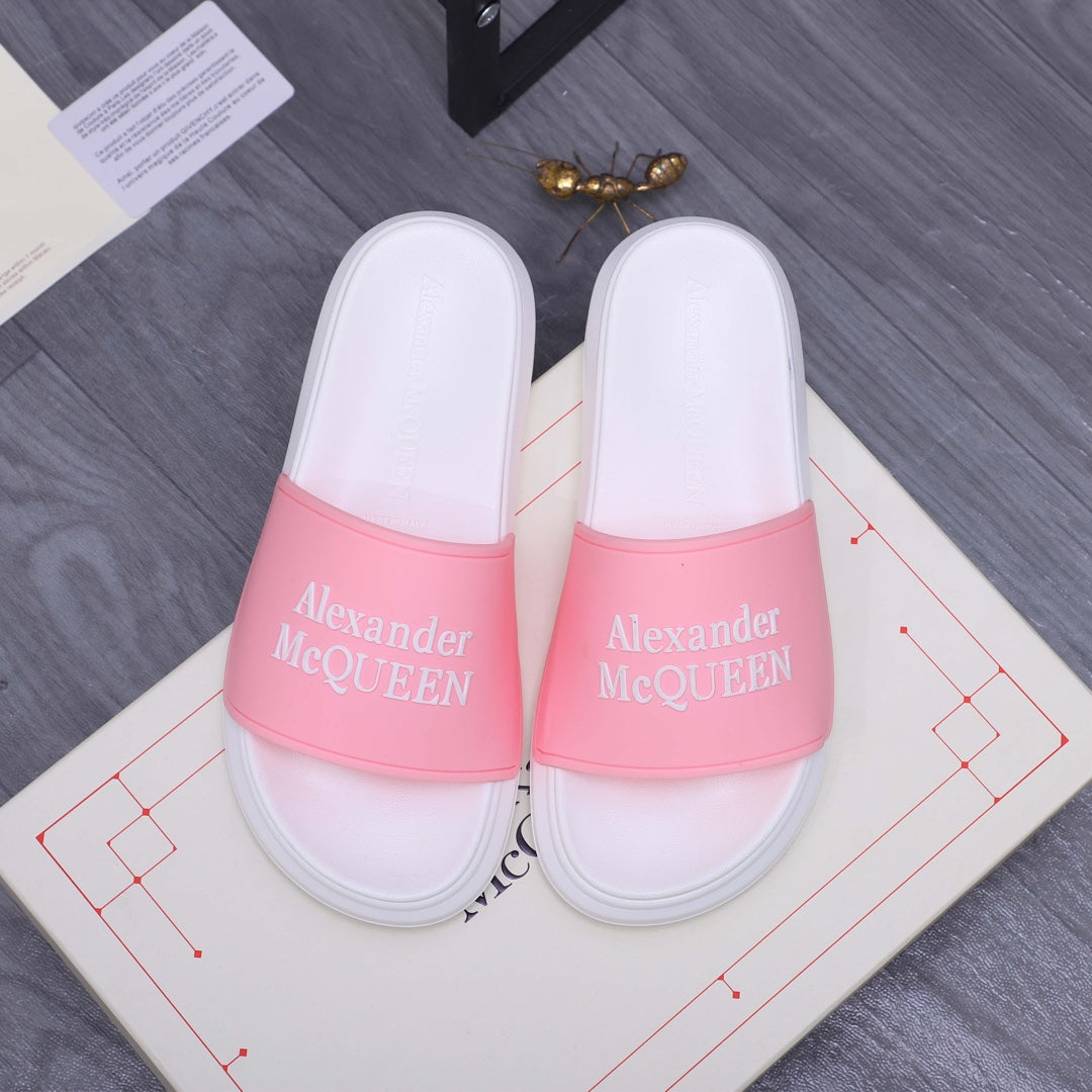 Alexander McQueen slide sandals with white footbed and pink logo strap band