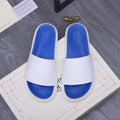 Alexander McQueen slides, white straps with blue footbeds and embossed logo