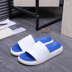 Alexander McQueen slides with white strap over blue footbed, flat slide sole