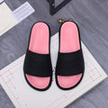 Slide sandals with black straps and pink footbeds, Alexander McQUEEN embossed on the band