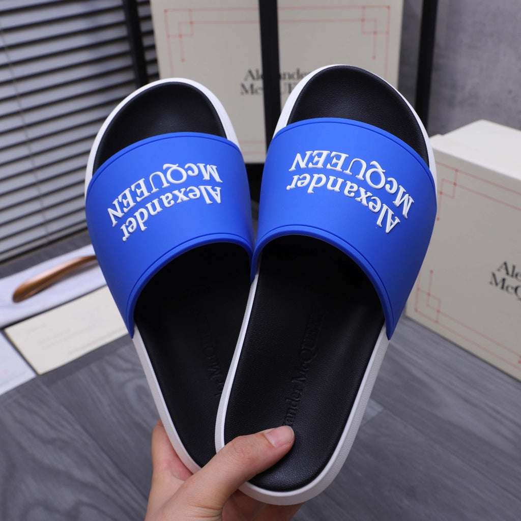 Alexander McQueen slide sandals, top view with blue logo straps and black footbeds