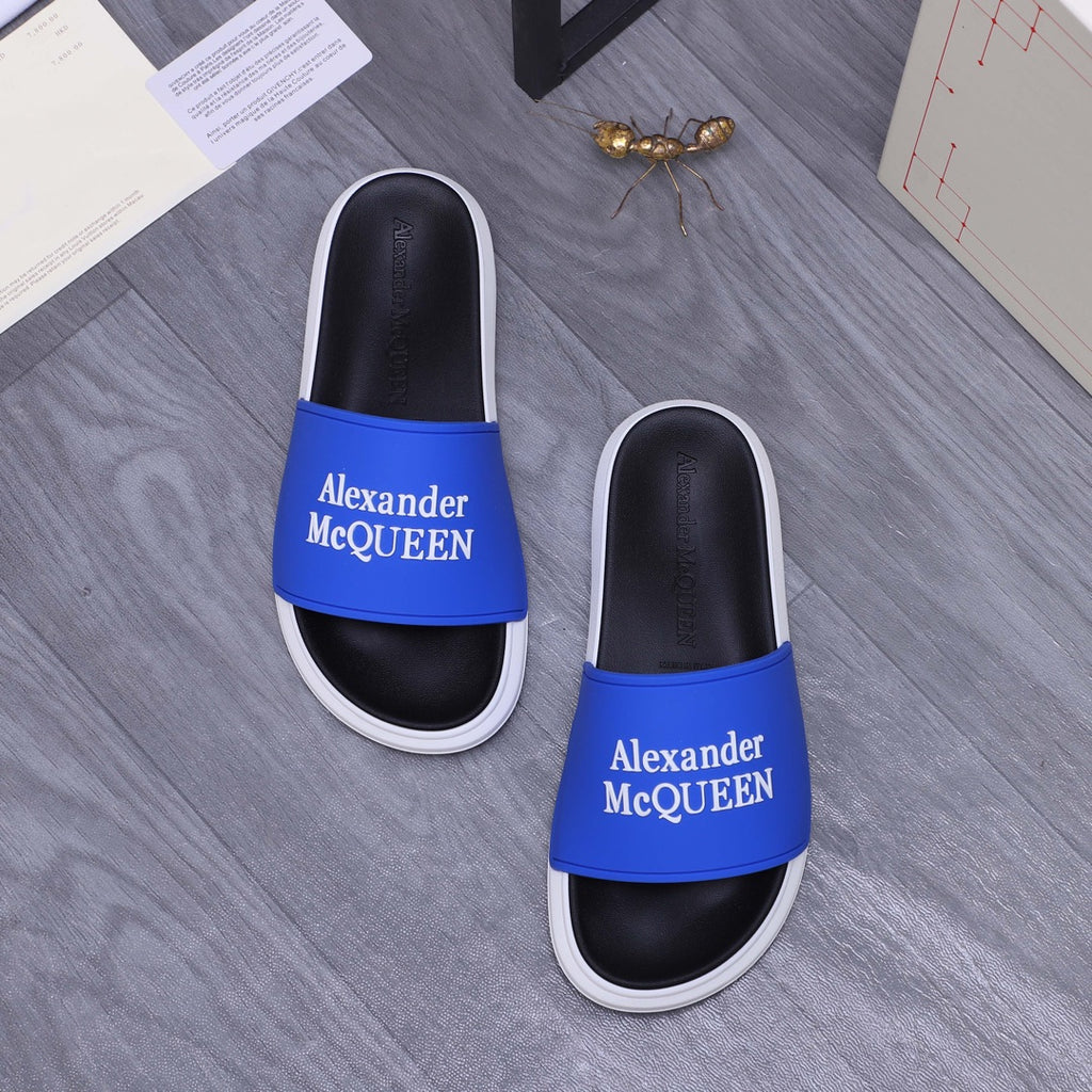 Alexander McQueen slide sandals with blue logo straps, black uppers, white midsoles