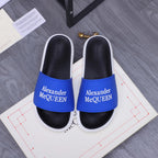 Alexander McQueen slide sandals with blue logo strap, black footbed, white sole
