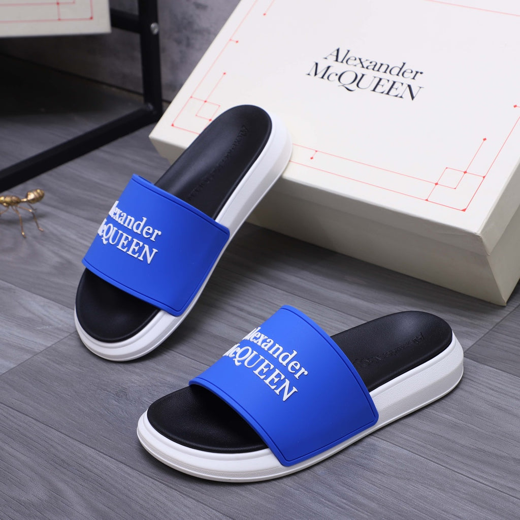 Alexander McQueen slide sandals pair with blue straps and white rubber soles