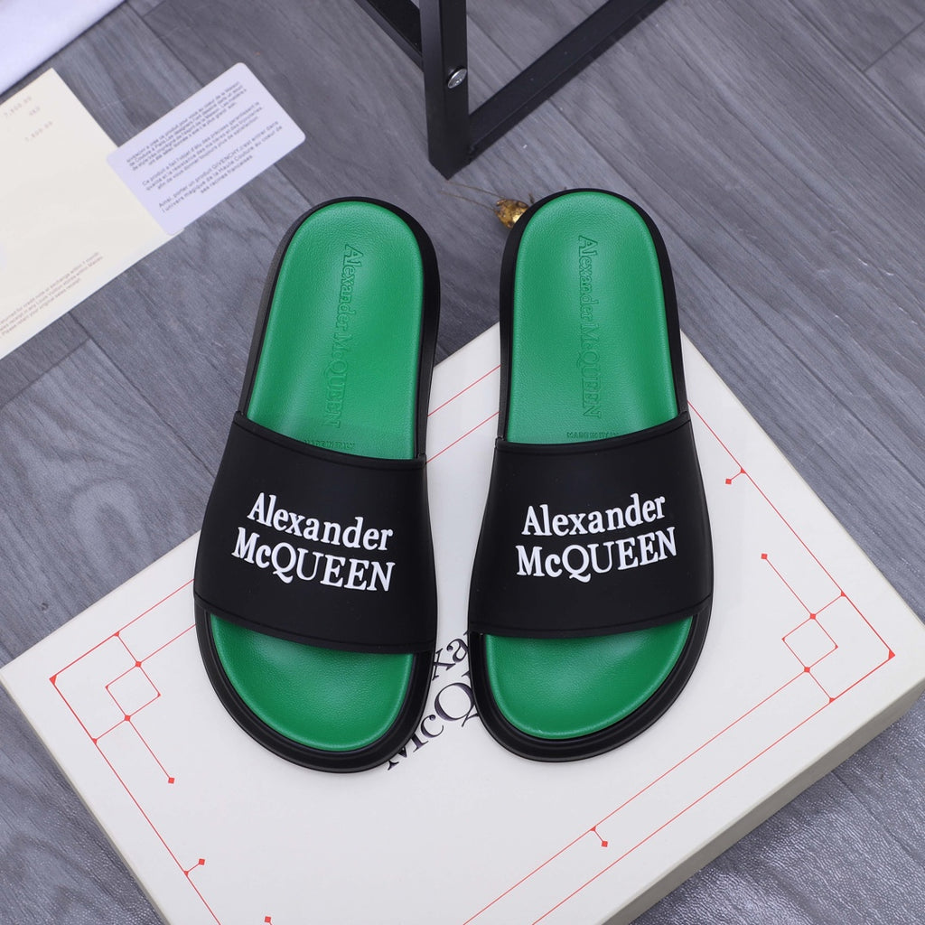 Green slide sandals with black strap and Alexander McQueen logo