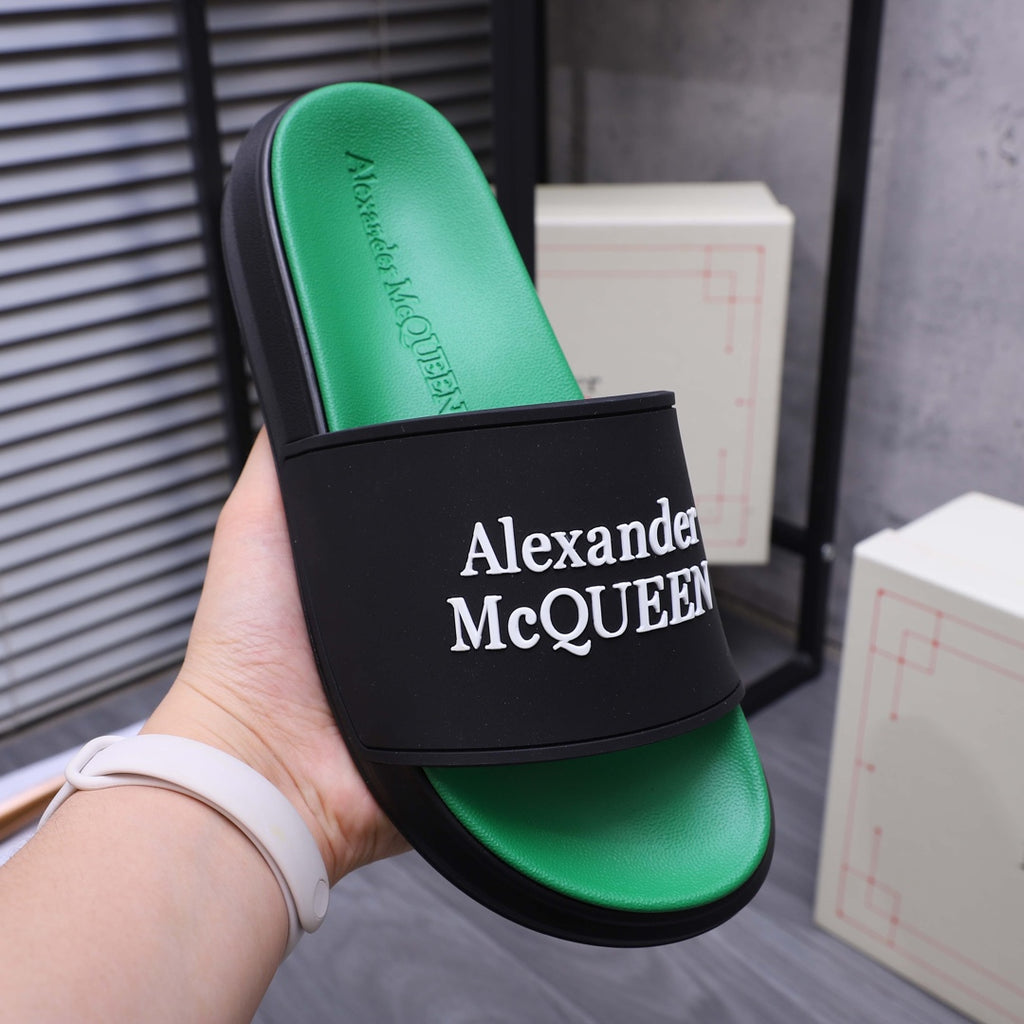 Green slide sandal with black band and Alexander McQueen branding on front
