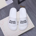 Alexander McQueen white leather slide sandals with logo strap, pair on box