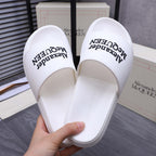 Alexander McQueen white slide sandals showing inner footbed with logo