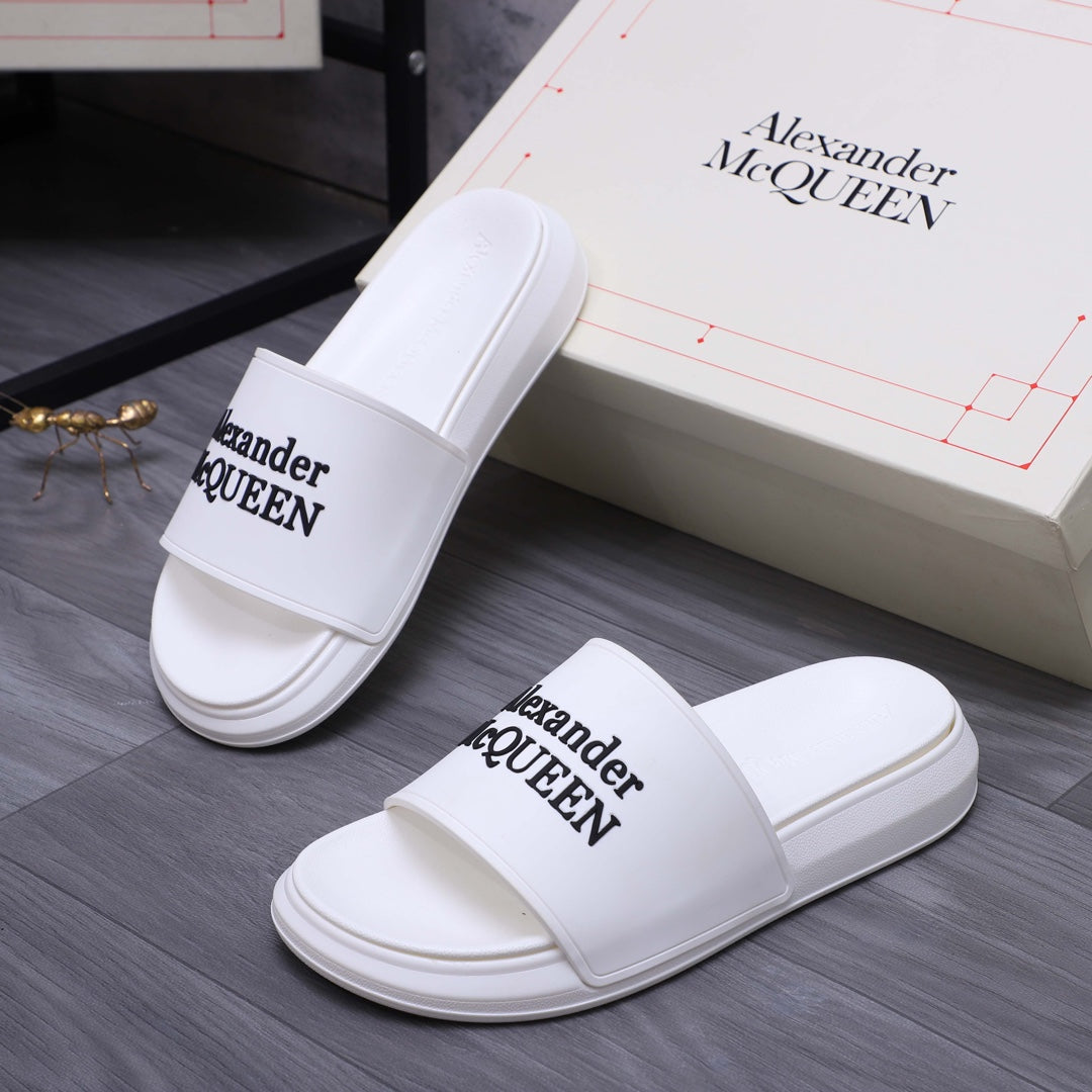 Alexander McQueen white leather slide sandals with logo straps, side view pair