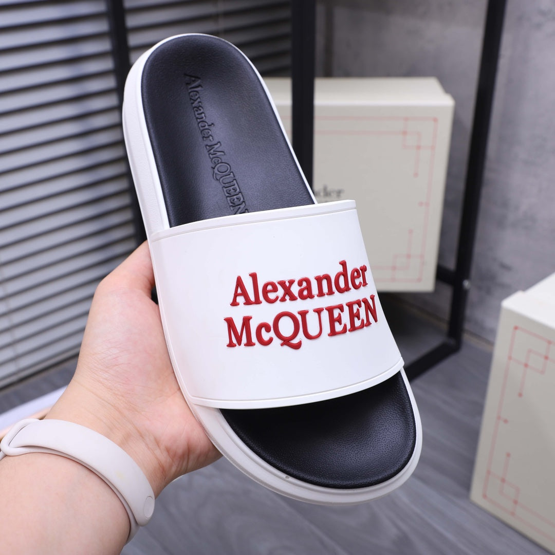 White slide sandal with red Alexander McQueen logo on wide strap, black footbed.