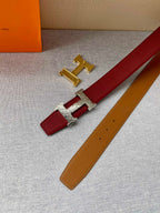 Red and tan leather belt with gold-tone H buckle and keeper tab