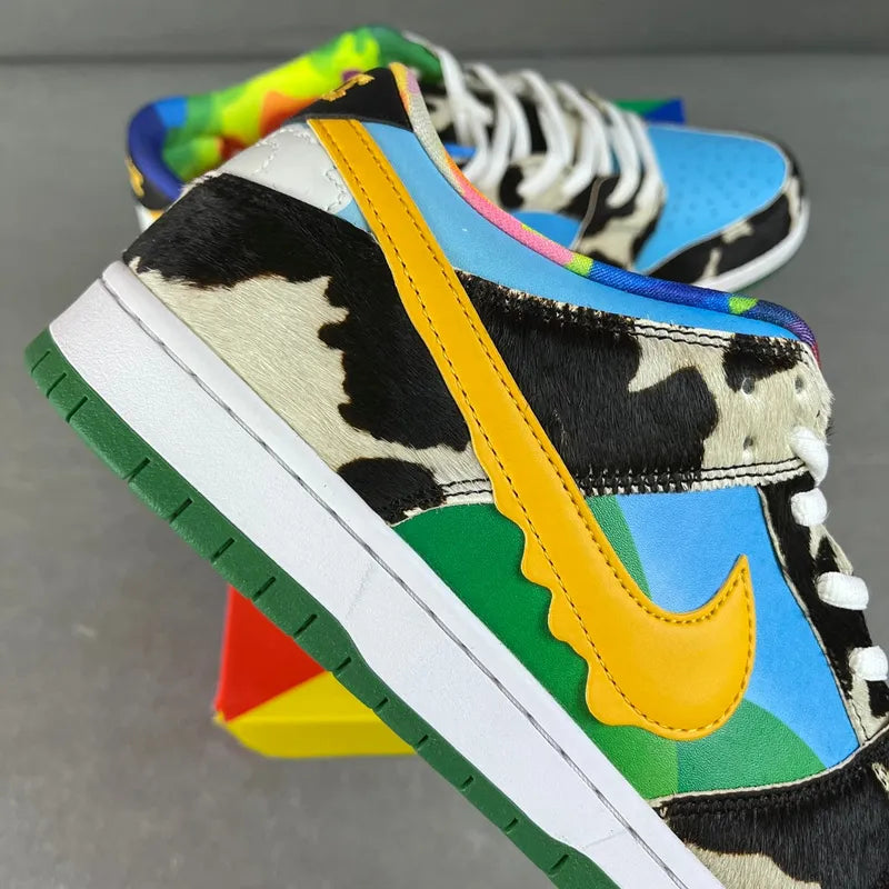 Colorful SB Dunk Low sneaker with yellow swoosh, black-and-white cow print side