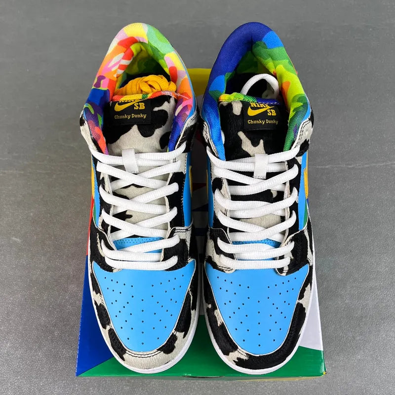 SB Dunk Low sneakers front view with white laces and multicolor inner lining, cow print