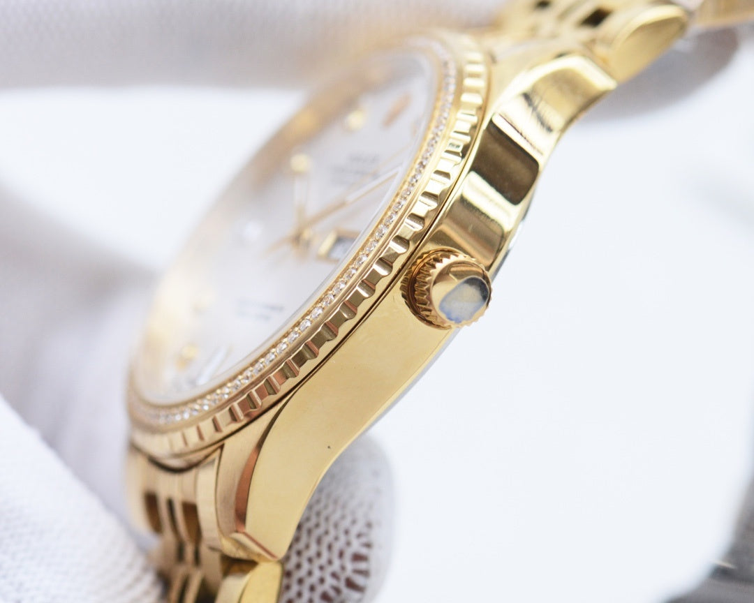Gold-tone Rolex watch case with crown and textured bezel detail
