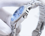 Rolex watch with blue dial and silver metal bracelet, angled side view