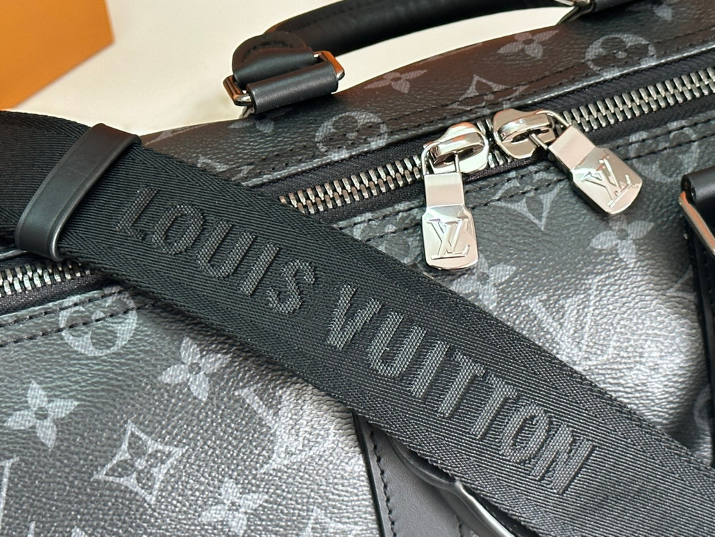 Louis Vuitton monogram bag with zipper pull and embossed dark shoulder strap