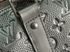 Men's Louis Vuitton monogram leather strap attachment with metal hardware