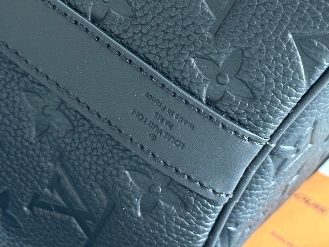 Men's Louis Vuitton leather bag with stitched panel and embossed monogram texture