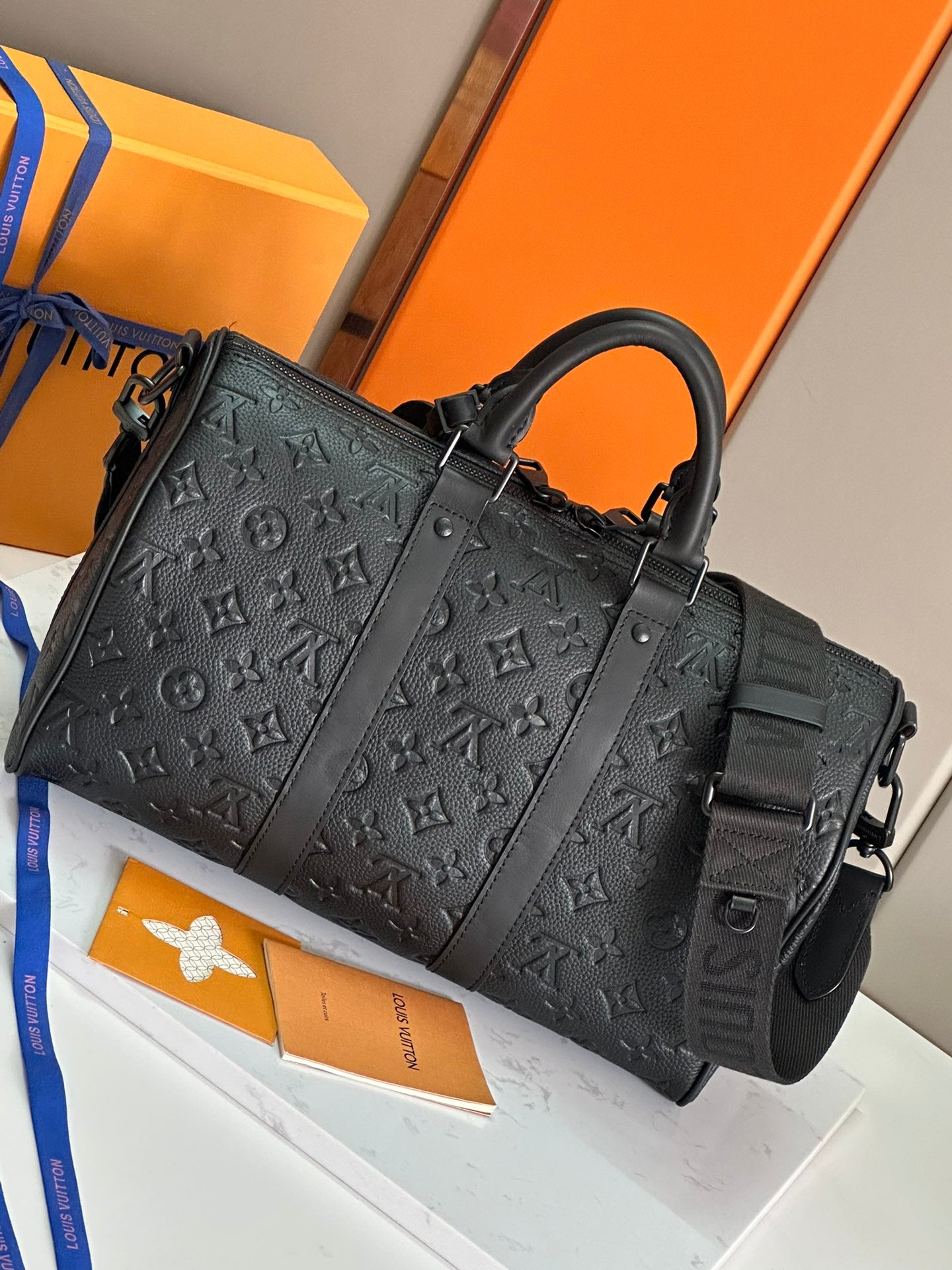 Men's Louis Vuitton monogram leather bag with structured panels and top handles