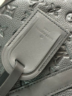Men's Louis Vuitton leather luggage tag detail on monogram bag