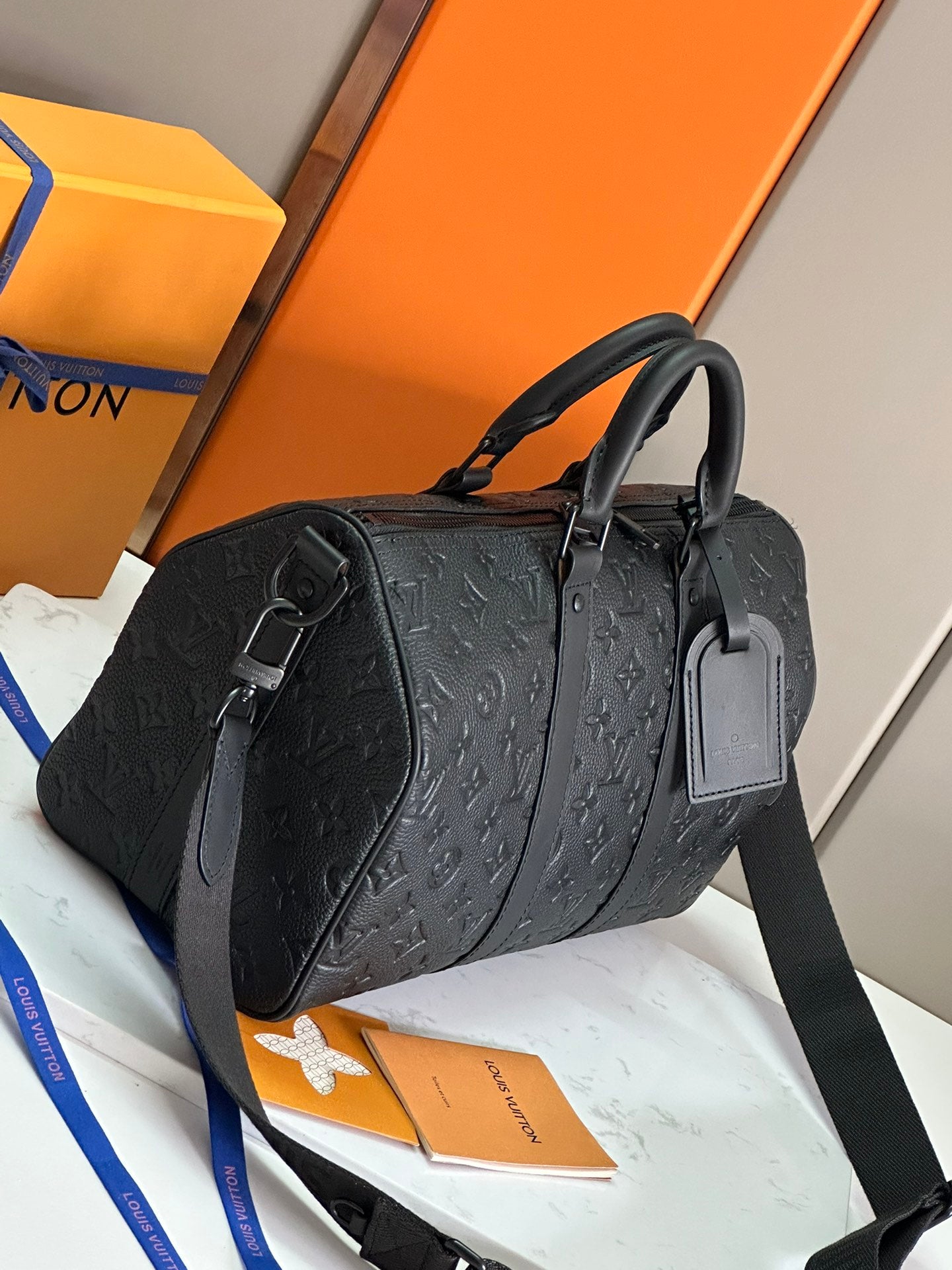 Men's Louis Vuitton monogram leather duffel bag with top handles and crossbody strap