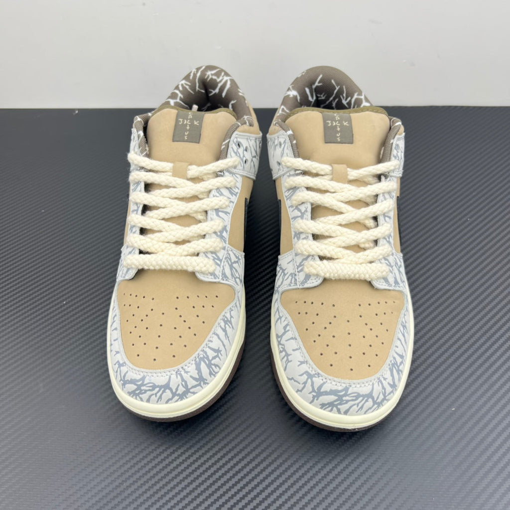 Nike Dunk SB low-top sneakers with beige laces, blue-and-white patterned toe and tan panels