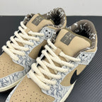 Nike Dunk SB sneakers close-up with beige laces, blue-and-white patterned overlays, tan tongue