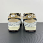 Nike Dunk SB sneakers with heel label, blue-and-white patterned panels, tan collar