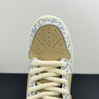 Nike Dunk SB toe box close-up with perforations, beige suede, and blue-white patterned trim