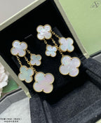 Gold-tone clover dangle earrings with iridescent mother-of-pearl, in black box