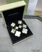 Clover mother-of-pearl dangle earrings with gold tone, laid in black jewelry box