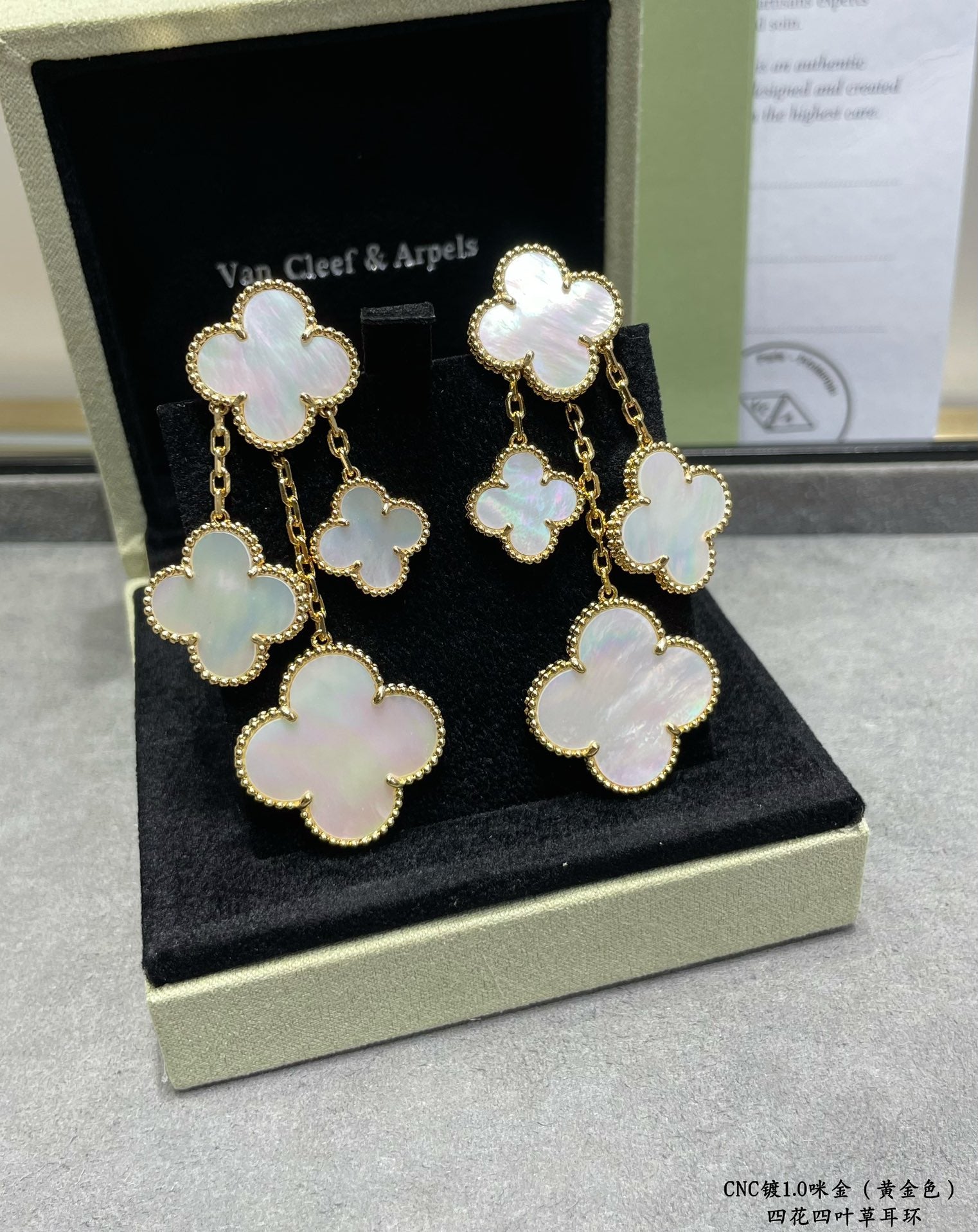Clover dangle earrings with gold-tone chains and mother-of-pearl charms in box