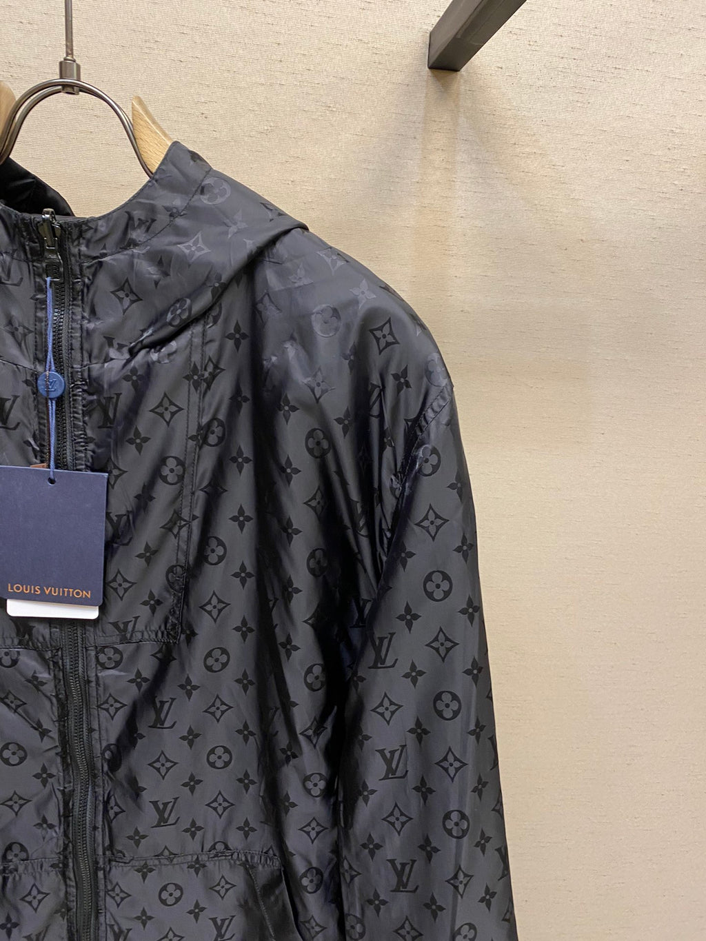 Black hooded jacket with all-over monogram pattern, full-zip front