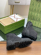 Gucci high-top sneakers with dark monogram upper and platform-style lug sole