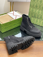 Gucci high-top lace-up sneakers in dark gray with monogram pattern and rugged outsole