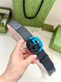 Designer belt with dark blue strap, monogram panel, and blue interlocking buckle