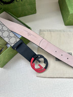 Gucci belt with pale pink lining, navy strap, and red-black circular G buckle