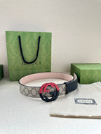 Gucci belt with GG canvas style strap and red circular G buckle