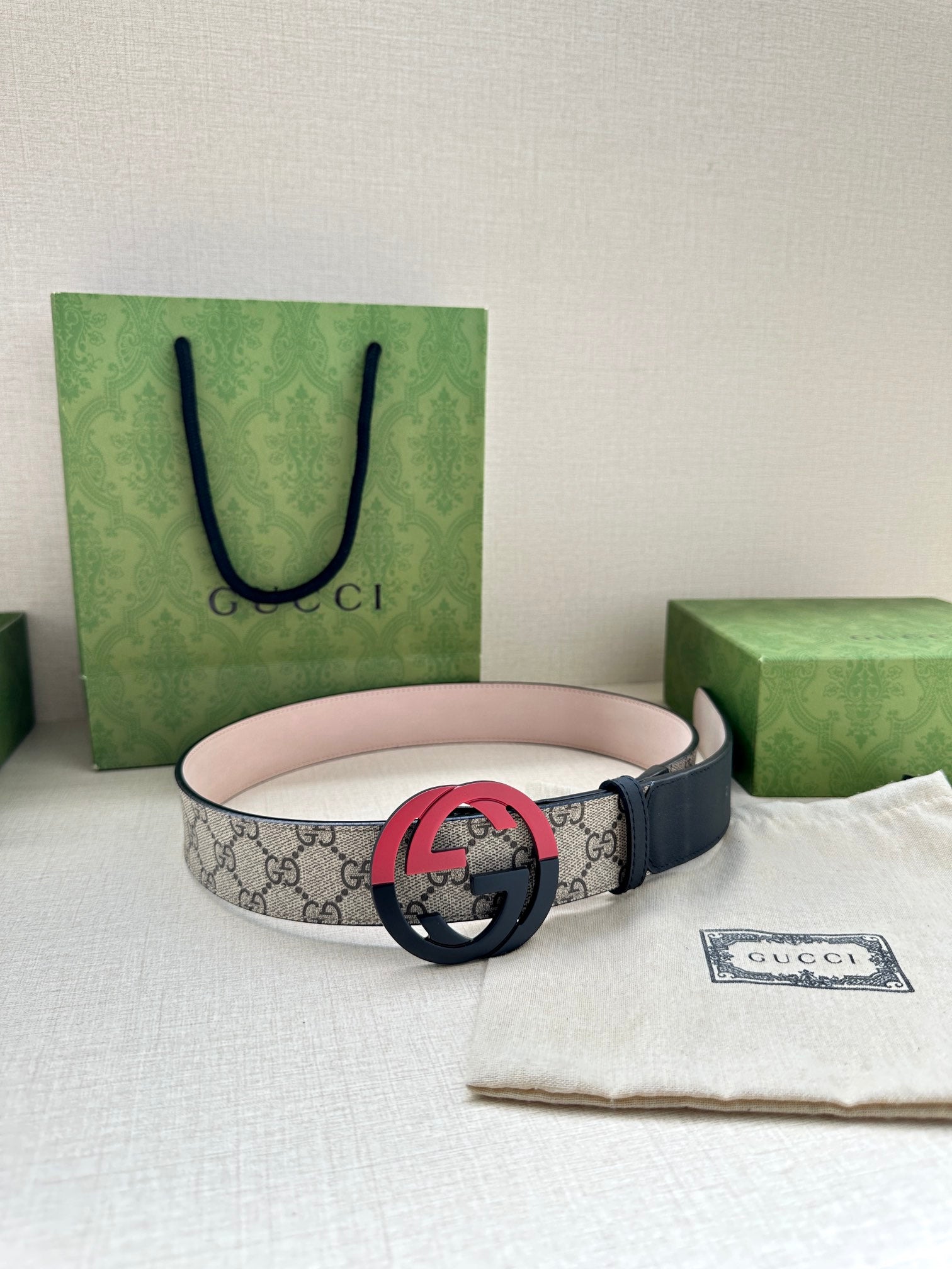 Gucci belt with GG canvas style strap and red circular G buckle