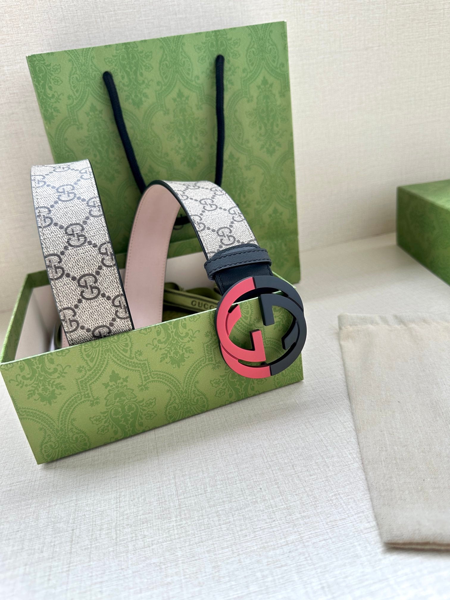 Gucci belt with GG canvas style strap and red-black circular G buckle