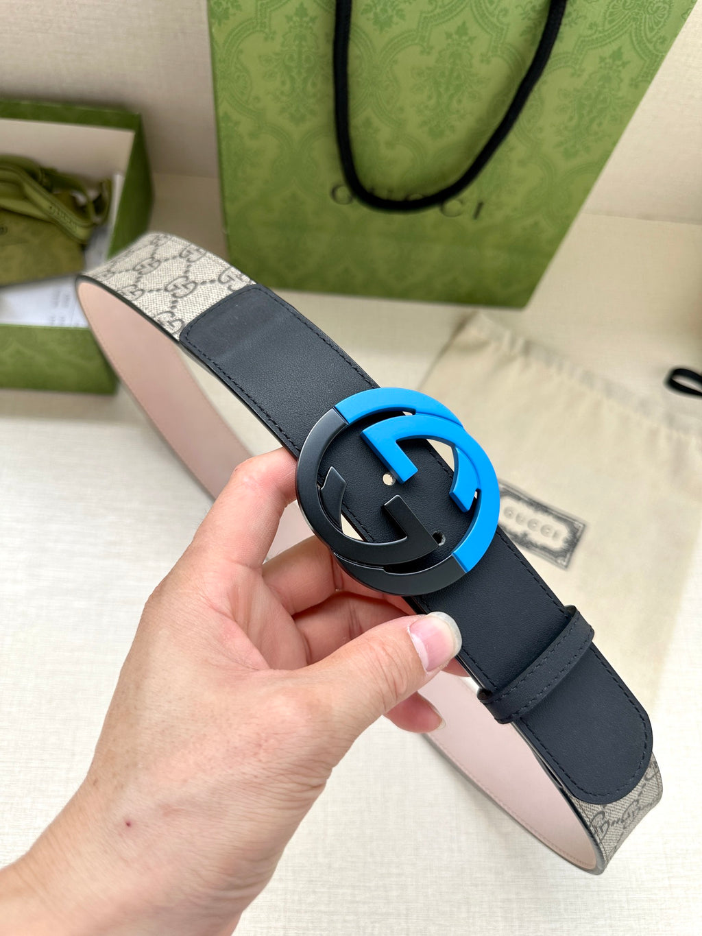 Gucci belt with navy leather strap and blue G buckle emblem