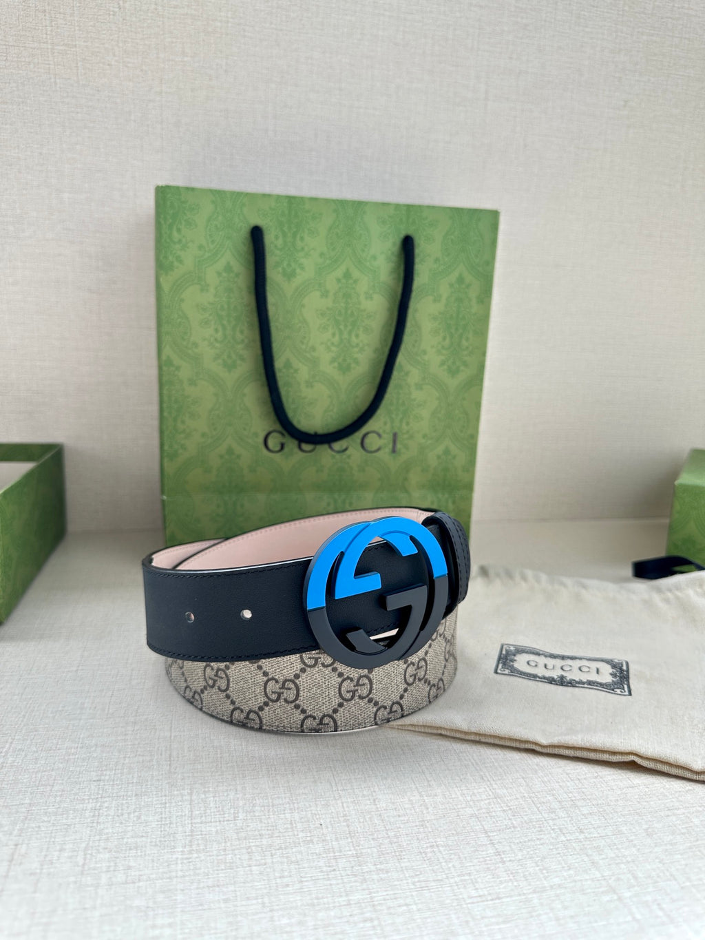 Gucci belt with GG canvas style strap and blue circular G buckle