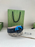 Gucci belt with GG canvas style strap and blue circular G buckle