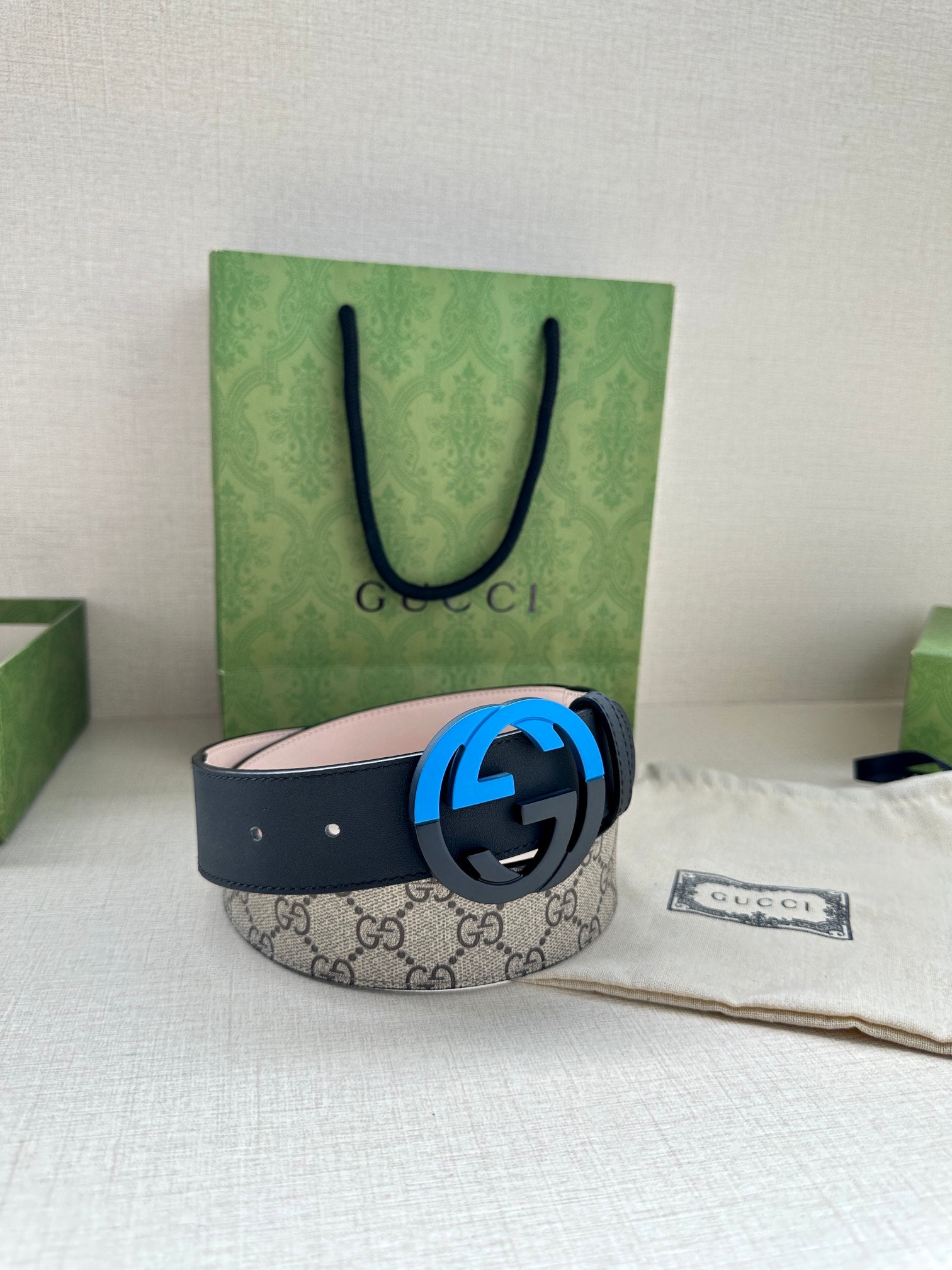 Gucci belt with GG canvas style strap and blue circular G buckle